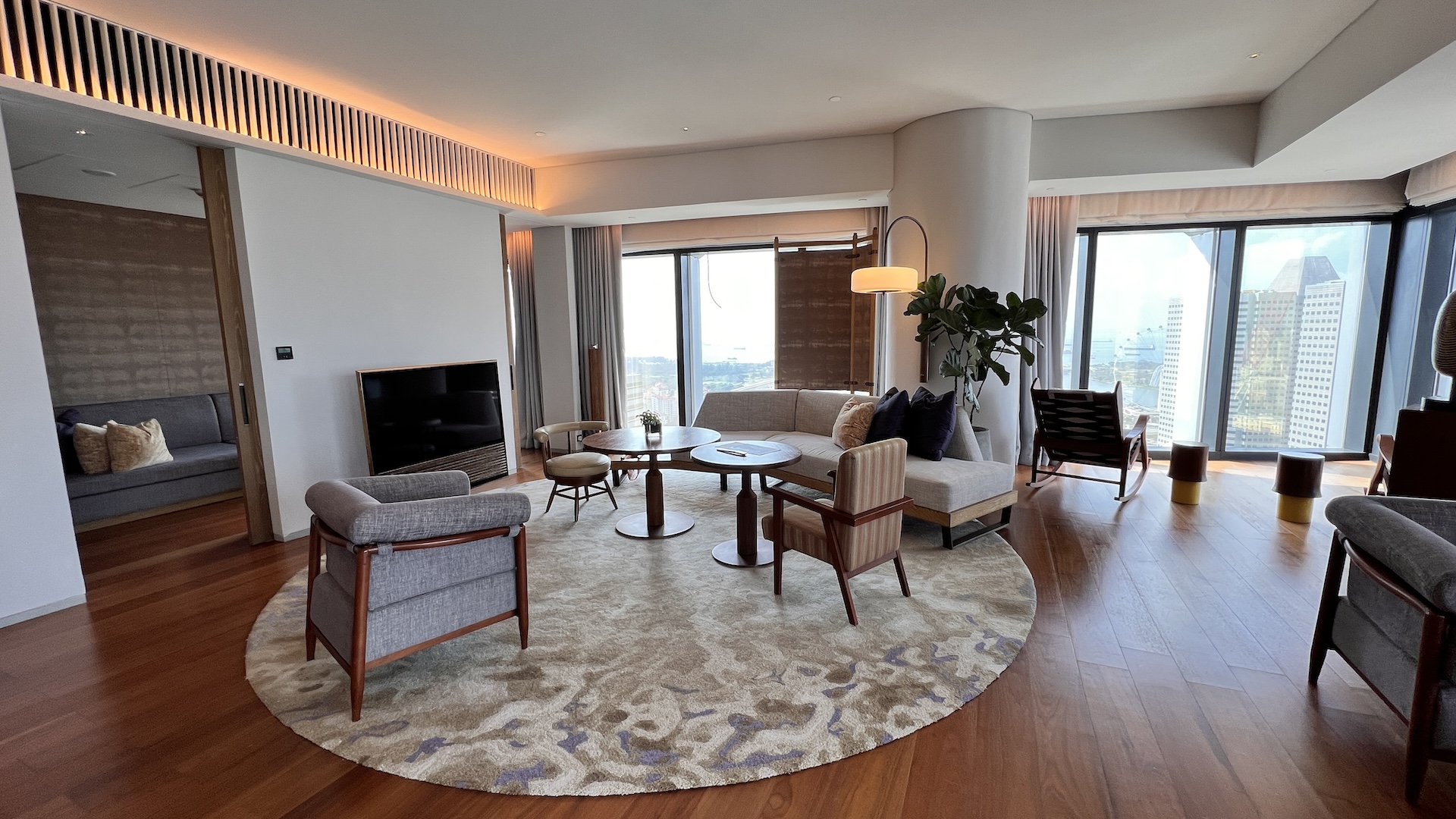 Sitting area of the Presidential Suite at Andaz Singapore with panoramic city views